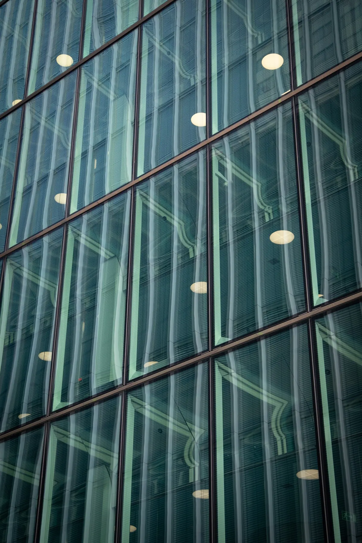 Glass building façade with reflections in its windows